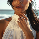 Load image into Gallery viewer, A woman wearing a white dress and a silver emerald cut eternity embrace ring.