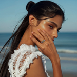 Load image into Gallery viewer, A person wearing a Canary Trio Silver Ring. The ring has a radiant canary yellow center stone with two smaller sparkling stones on either side, set in a classic three-stone design.