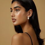 Load image into Gallery viewer, A woman wearing silver drop earrings with pearls, gazing off to the side.