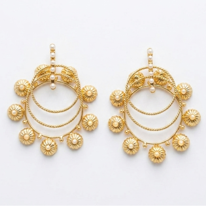 Pair of gold earrings on a white background