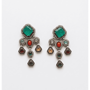 Multi-stone chandelier earrings with emerald green square studs, red oval stones, pearl accents, and dangling geometric charms in antique silver finish.