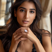 A person wearing a silver ring with a lab-grown emerald-cut stone.