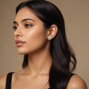A woman wearing silver floral stud earrings.