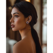 A person viewed from the side wearing the Crimson Rhapsody Ruby Silver Studs earrings.